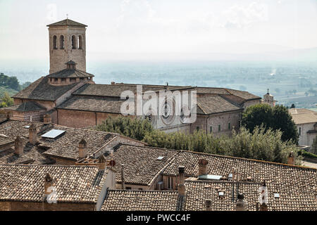 church and bell tower of San Pietro with the roofs of Assisi. Perugia, Umbria, Italy Stock Photo