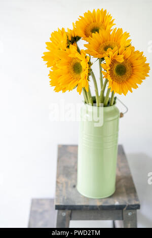 Bouquet of yellow sunflowers , flower in vase on old vintage table. Room morning. Gray background. Colors of autumn and mood fall Stock Photo