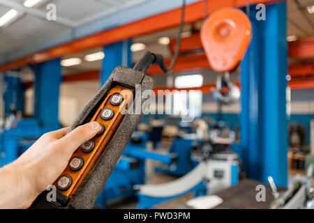 close up remote control switch for overhead crane in manufacture workshop Stock Photo