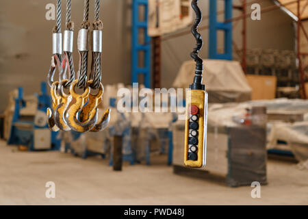 Movement remote control pendant switch for overhead crane in the factory Stock Photo