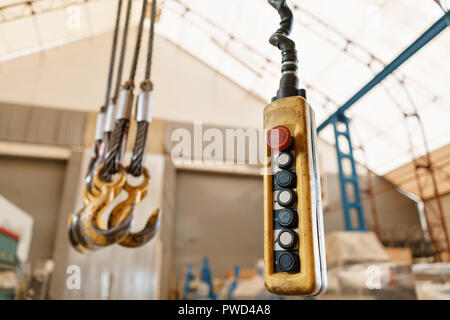 Movement remote control pendant switch for overhead crane in the factory Stock Photo