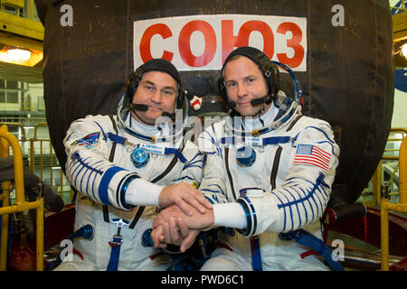 Expedition 57 crew member cosmonaut Alexey Ovchinin of Roscosmos, left, and Nick Hague of NASA pose in front of the Soyuz MS-10 spacecraft in their Sokol launch and entry suits at the Baikonur Cosmodrome September 26, 2018 in Baikonur, Kazakhstan. The two are scheduled to launch on October 11th and will spend the next six months living and working aboard the International Space Station. Stock Photo