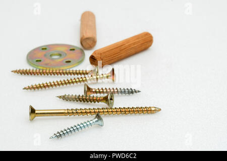 metal screws and wooden plugs Stock Photo