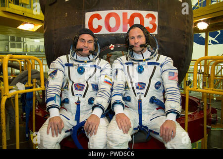 Expedition 57 crew member cosmonaut Alexey Ovchinin of Roscosmos, left, and Nick Hague of NASA pose in front of the Soyuz MS-10 spacecraft in their Sokol launch and entry suits at the Baikonur Cosmodrome September 26, 2018 in Baikonur, Kazakhstan. The two are scheduled to launch on October 11th and will spend the next six months living and working aboard the International Space Station. Stock Photo