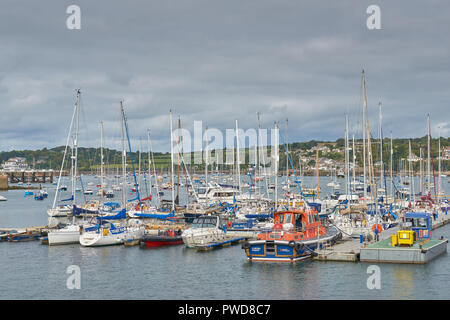 Sailing boats and a pilot ship moored in the harbor of Falmouth, Cornwall, England, with the Roseland peninsulal in the background. Stock Photo