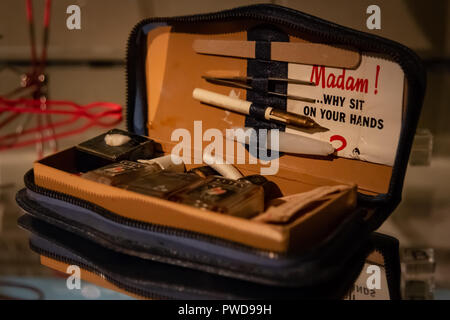 A vintage women's manicure set with a card that reads "Madam! Why sit on your hands?" on display at the Costume Gallery in the Pitti Palace in Florence, Italy. Stock Photo