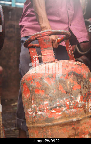 Worker delivering LPG gas cylinders into the truck for customers Stock Photo