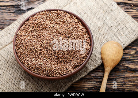 raw buckwheat in a plate on a wooden table. place for text Stock Photo