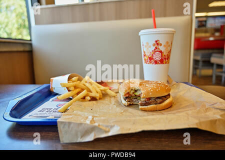 Burger King whopper hamburger, french fries and cold drink meal on the fast food restaurant dinner tray. Stock Photo