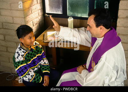 Catholic priest blessing child with hand held over Child's head during reconciliation.  © Myrleen Pearson  ....Ferguson Cate