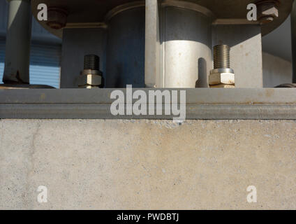 Stainless steel mounting plate fixed to concrete with stainless steel anchor bolts, supporting Vertical axis wind turbine in Cleveleys lancashire uk Stock Photo