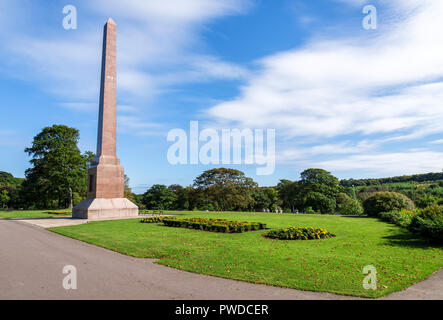 Magnificent McGrigor Obelisk with flower beds in front on a blue sky background, Duthie Park, Aberdeen, Scotland Stock Photo