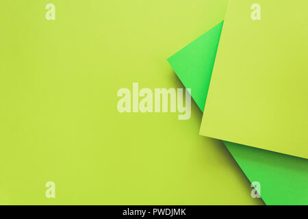 Green and lime pastel color papered background. Volume geometric flat lay. Top view. Copy space. Toned Stock Photo