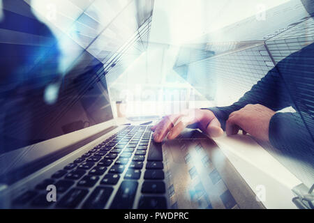Business man works in office with laptop in the foreground. Concept of teamwork and partnership. double exposure with network effects Stock Photo