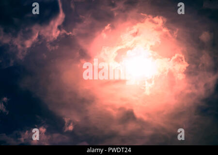 Beautiful dark sky with sun and clouds Stock Photo
