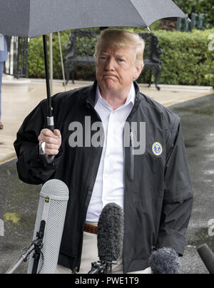 Washington, District of Columbia, USA. 15th Oct, 2018. United States President DONALD J. TRUMP speaks to reporters as he prepares to depart the White House in Washington, DC for a day trip to Florida and Georgia to view Hurricane damage. Credit: Ron Sachs/CNP/ZUMA Wire/Alamy Live News Stock Photo