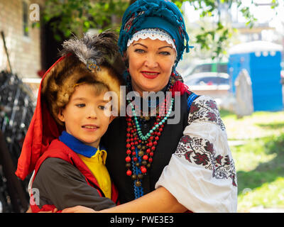 Boryspil, Ukraine. 14th Oct 2018. Beauty Ukranian woman in national costume with son. — The Protection of the Virgin is a national holiday celebrated by the Ukrainian Orthodox Church. On this day, at the same time, the holiday of the Ukrainian Cossacks, the Day of the creation of the Ukrainian Rebel Army and the Day of Defender of Ukraine are celebrated. Credit: Igor Golovnov/Alamy Live News Stock Photo