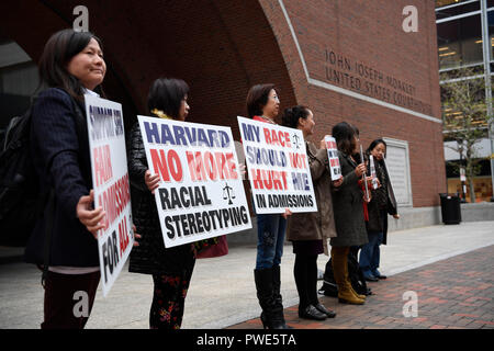 Boston, USA. 15th Oct, 2018. Demonstrators hold slogans in front of John Joseph Moakley United States Courthouse in Boston, Massachusetts, the United States, on Oct. 15, 2018. A lawsuit charging Harvard University of discriminating against Asian American applicants in admissions went to trial on Monday at a U.S. District Court in Boston, drawing nationwide attention as the future of the affirmative action is also on the debate. TO GO WITH Spotlight: Trial starts over racial discrimination charges against Harvard in admissions. Credit: Liu Jie/Xinhua/Alamy Live News Stock Photo