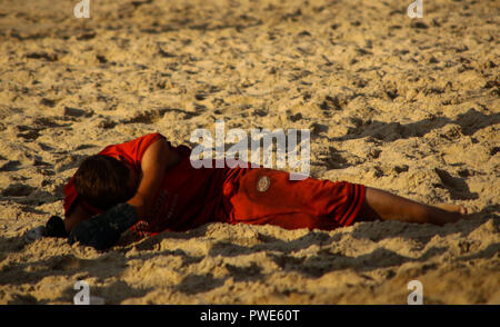 October 15, 2018 - Dozens of Palestinian protesters are injured during clashes with the Israeli army on a beach in northwestern Gaza, close to the border with Israel, on 15th October 2018. Injured protesters were rescued by paramedics after being hit by Israeli live gunfire and being asphyxiated by tear gas. Hundreds of demonstrators had gathered on the beach near Beit Lahiya to demand the lift of the Israeli blockade on Gaza, which Israel has imposed since 2007, as Hamas took over power in the Strip, and which has been strangling the Palestinian enclave and causing a humanitarian crisis for t Stock Photo