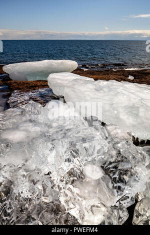 Crystal clear ice washed up on the the shore of Gooseberry Falls State Park. Stock Photo