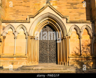 Arched ornate doorway with elaborate door, Victorian St Mary's Episcopal Church, Dalkeith, Midlothian, Scotland, UK Stock Photo