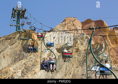 Chairlift. People enjoying spectacular views over Alum Bay and beach. Isle of Wight. Breathtaking rides  down to the beach and back up again. Stock Photo