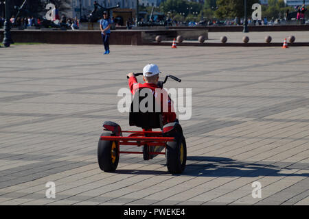 Novorossiysk, Russia - September 29, 2018: Children ride in the park on cars with pedals. Admiral Serebryakov Square. Childrens leisure. Stock Photo