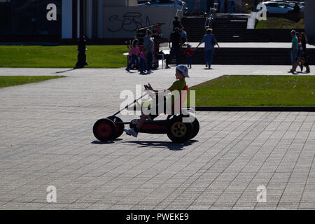 Novorossiysk, Russia - September 29, 2018: Children ride in the park on cars with pedals. Admiral Serebryakov Square. Childrens leisure. Stock Photo