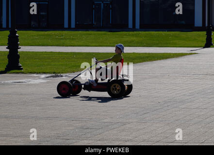 Novorossiysk, Russia - September 29, 2018: Children ride in the park on cars with pedals. Admiral Serebryakov Square. Childrens leisure. Stock Photo