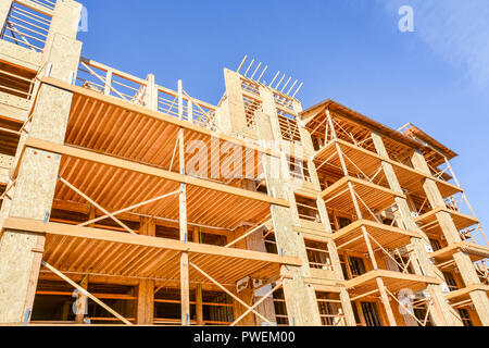 Six storey frame building under construction on concrete foundation bed ...