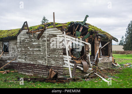 Old abandoned house in disrepair on cold fall day before final demolition Stock Photo