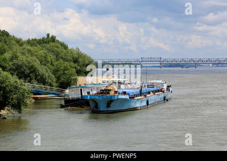 Romania, Giurgiu at the Danube, Muntenia, Greater Wallachia, harbour Giurgiu, freighter at a landing stage, behind the Friendship Bridge between Giurgiu in Romania and Russe or Ruse or Rousse in Bulgaria, Danube bridge, road bridge, railway bridge, Danube landscape, river landscape Stock Photo