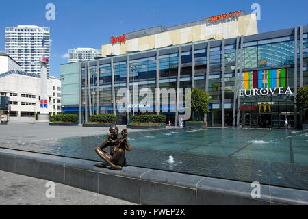 Slovak Republic, Slovakia, Bratislava, Capital City, Danube, Little Carpathians, Eurovea Gallery, shopping center, department stores, business houses, commercial tower, bronze skulptur at a fountain, young woman with mirror in her hand applies makeup, people
