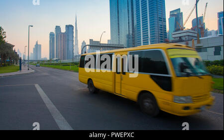 Dubai city downtown and bus moving on the road Stock Photo