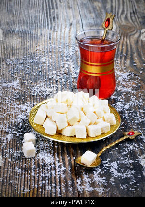 dried coconut  and tea on wooden table Stock Photo