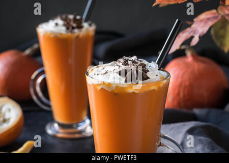 Fresh pumpkin smoothie or juice on dark. Autumn, fall or winter hot drink. Cozy healthy beverage. Stock Photo