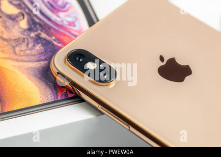 12th October,2018-Kiev,Ukraine: Latest Iphone XS on opened box on white table. Newest Apple smartphone on white branded box in mobile store. Modern gadget with dual camera and OLED screen for sale Stock Photo
