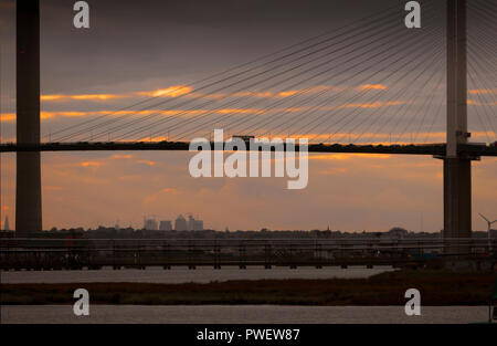 A London bus crosses the River Thames over the Dartford Crossing or Queen Elizabeth Bridge between Essex and Kent, England. Stock Photo