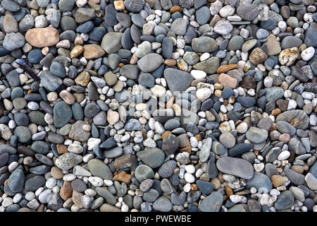 Textured pebbles on a beach Stock Photo
