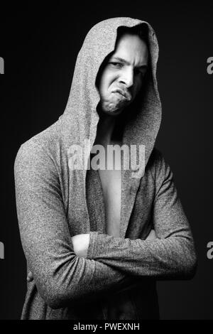 Rebellious man against black background in black and white Stock Photo