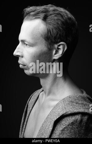 Rebellious man against black background in black and white Stock Photo