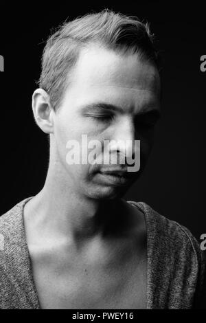 Rebellious man against black background in black and white Stock Photo