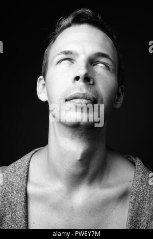 Rebellious man against black background in black and white Stock Photo