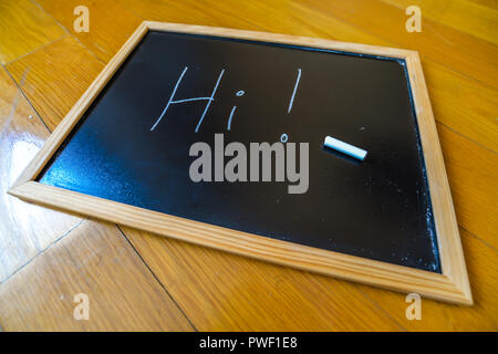 Hi written on a chalk board Stock Photo