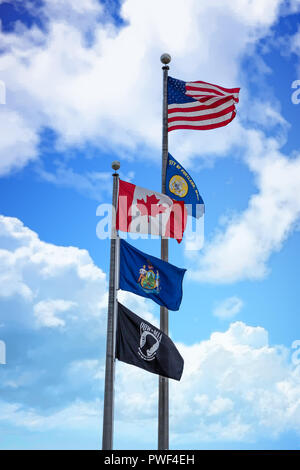 American, Maine, Portland, Canadian and MA/POW flags flying in Portland, Maine under nice skies Stock Photo