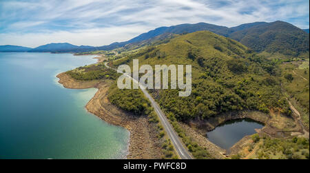 Rural highway along Tumut River coastline and mountains. Blowering, NSW, Australia - aerial panoramic landscape Stock Photo