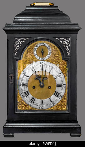 Antique table clock housed in carved wooden box on isolated gray background with clipping path. Stock Photo