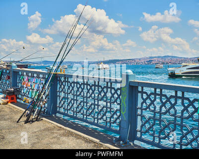 Fishing rods on the Galata bridge, over the Golden Horn Bay with the Uskudar district in the background. Istanbul, Turkey. Stock Photo