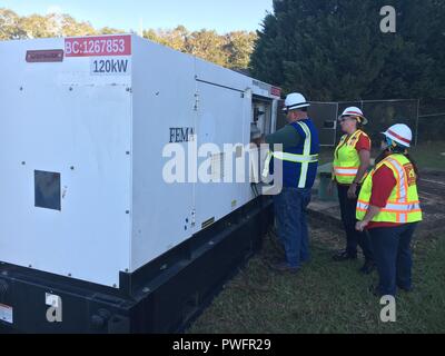 The first emergency generator in USACE's Emergency Power Mission in Georgia was installed last night and is supporting critical wastewater infrastructure in Albany with emergency temporary power while the larger commercial grid continues to be restored, October 13, 2018. Shown: Emergency Power Planning and Response Team personnel from the Savannah District oversee the installation. The Emergency Power Mission is being managed by the U.S. Army Corps of Engineers there in support of FEMA Federal Emergency Management Agency as part of the larger federal response to Hurricane Michael. (Photo by Ch Stock Photo