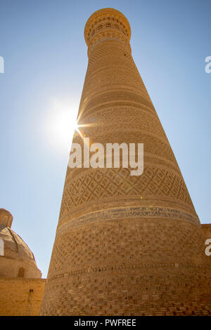 Solar flare around Tower of Death, or Kalan Minaret, in Bukhara, Uzbekistan. Stock Photo